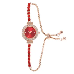 Elegant ladies quartz watch with red rhinestone dial and adjustable gold bracelet chain