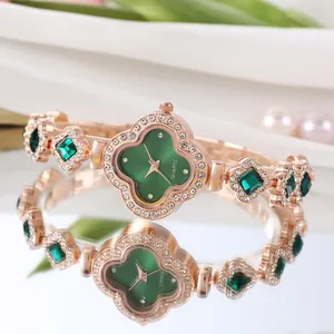 Detail of rose gold clover watch with emerald green dial and crystal embellishments