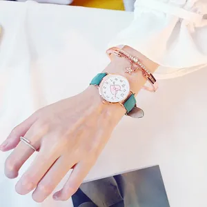 Detail of teal leather watch with heart dial and matching rose gold star bracelets