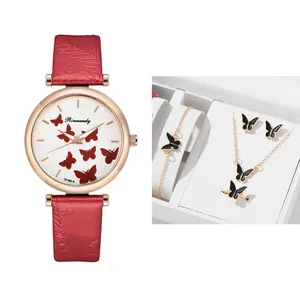 Detail showing the red butterfly quartz watch set with matching jewelry in a gift box