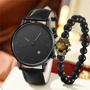 Macro shot of black leather strap watch with roman dial and crown beaded bracelet