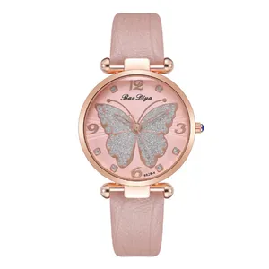 Detail of rose gold watch featuring a pink leather strap and silver glitter butterfly dial