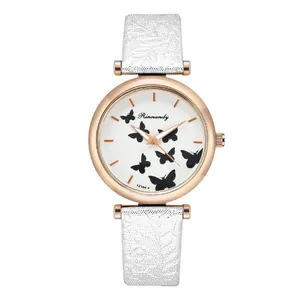 Detail shot of the white leather strap with lace texture and rose gold butterfly watch case