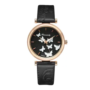 Close-up of butterfly quartz watch with floral embossed black leather strap