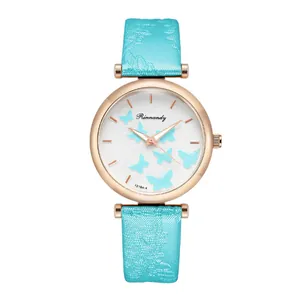 Detail of light blue butterfly pattern quartz watch with rose gold case and leather strap