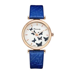 Detail of the rose gold quartz watch featuring butterfly prints and a blue textured strap