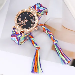 Detail of rose gold butterfly watch dial with a colorful bohemian woven tassel strap