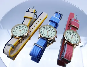 Detailed view of three quartz watches with striped NATO nylon straps on a reflective base