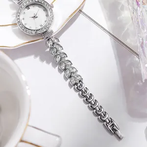 Elegant women's silver quartz watch with rhinestone leaf bracelet and white dial