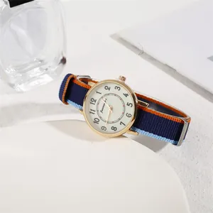 Macro view of minimalist watch dial with Arabic numerals and vibrant nylon NATO strap