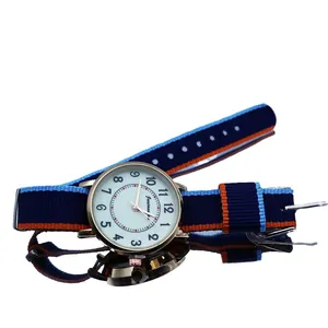 Luminous quartz watch with gold case and blue orange striped nylon strap on white background