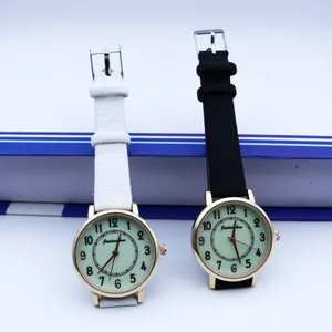 Luminous quartz watch for women with golden round case and leather strap in black and white