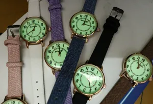 Flat lay of quartz watches with colorful leather straps and luminous rose gold dials
