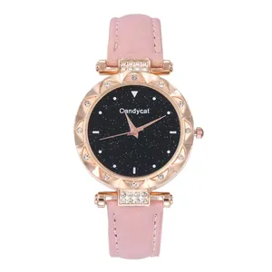 Detail of rose gold watch with pink strap, rhinestone bezel and starry black dial