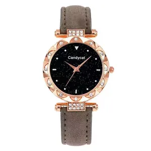 Detail of rose gold watch case with rhinestone bezel and starry sky dial on gray strap