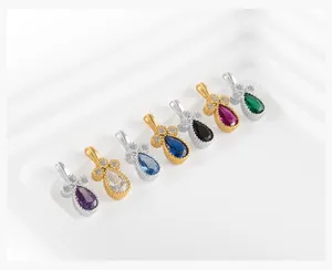 Detailed view of colorful teardrop pendants with pavé diamonds in silver and gold plating