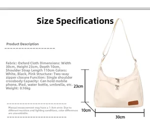 Detail view of cream nylon crossbody bag with dual zippers and size dimensions info