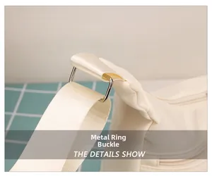 Detail showing the silver hardware buckle and nylon texture of the cream crossbody bag
