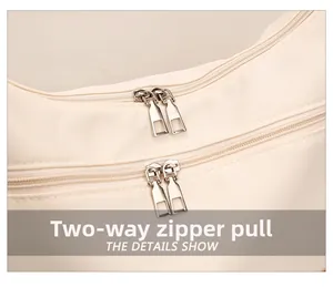 Detail shot of the beige nylon bag showing the durable two-way metal zipper functionality