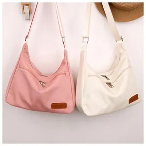Detail of waterproof crossbody bags showing large capacity and front dual zippers