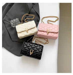 Detailed view of quilted chain bags in beige, pink and black with gold metal clasps