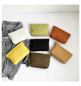 Detailed view of quilted floral makeup bags in seven vibrant colors for storage