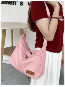 Detailed close-up of pink Hobo bag with adjustable strap and metal zipper pockets