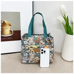 Bolso de lona para almuerzo con estampado de gatos y smartphone para referencia de tamaño