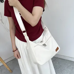 White waterproof nylon crossbody dumpling bag with wide strap and fashion logo