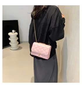 Detail of pink quilted crossbody bag with glossy finish and gold H-lock closure