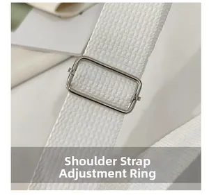 Detailed close-up of white woven shoulder strap with silver adjustable metal buckle
