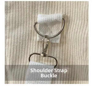 Detail shot of the durable metal shoulder strap buckle and corduroy fabric texture