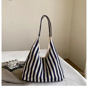 Détail d'un grand sac fourre-tout en toile à rayures bleues et blanches montrant la texture