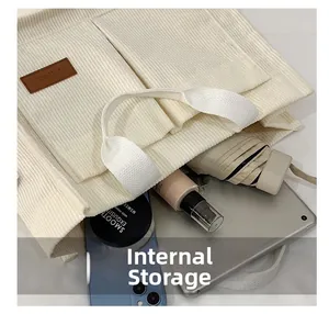 Internal storage view of the corduroy tote bag showing spacious room for essentials