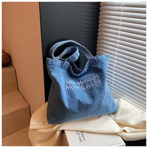 Aesthetic denim tote bag with Less Mondays More Sundays embroidery on textured fabric