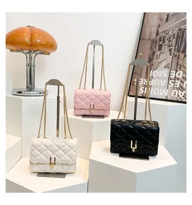 Quilted diamond lattice shoulder bags in white, pink and black with gold metal clasps