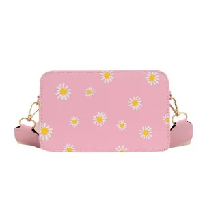 Pink daisy print crossbody bag for women with wide shoulder strap and gold hardware