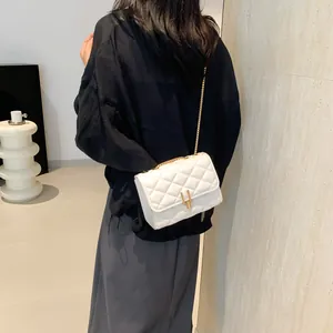 White quilted crossbody bag with gold chain strap and elegant geometric metal lock