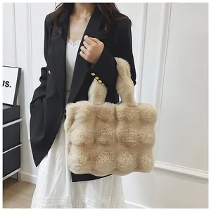 Detailed macro view of beige faux fur quilted tote bag with soft plush texture