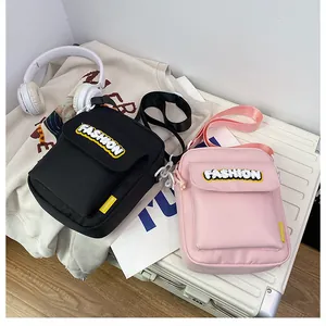 Detailed shot of canvas messenger bags with fashion letter embroidery on a suitcase