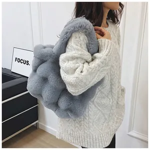 Close-up of grey faux fur tote bag with bubble texture and plush shoulder straps