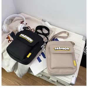 Detail of canvas messenger bags in black and beige with adjustable shoulder straps