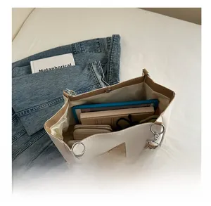 Interior detail of large tote bag showing space for tablet, books, and daily items