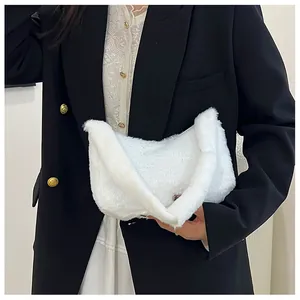 Close-up of fluffy white faux fur handbag with soft texture and curved crescent handle