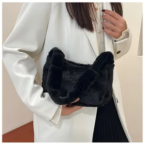 Close-up of black faux fur handbag paired with white blazer and black pleated skirt