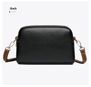 Back view of minimalist black shell bag with lychee texture and gold metal lobster clasp