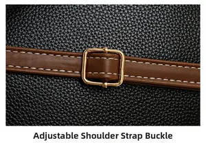 Detail of adjustable golden metal buckle on a brown leather strap with stitching
