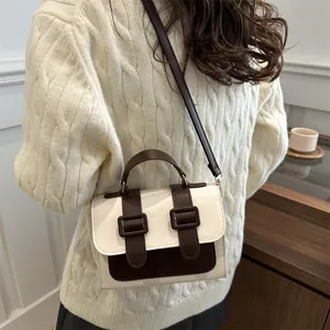Two-tone vintage square crossbody bag in cream and dark brown faux leather with buckles