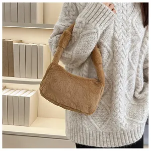 Detail of soft brown faux fur texture and sturdy top handle on a plush shoulder bag