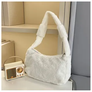 Detail showing the plush white faux fur texture and silver zipper on the mini handbag